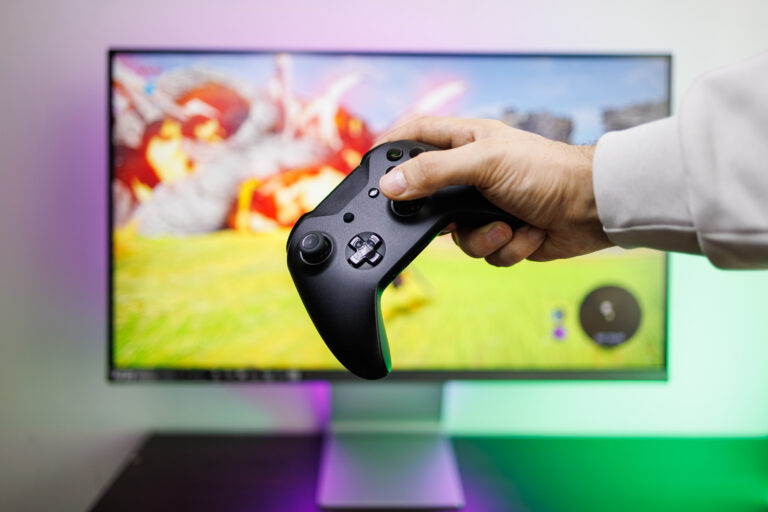 hand-holding-controller-playing-video-game-at-home-2026-03-24-10-08-08-utc